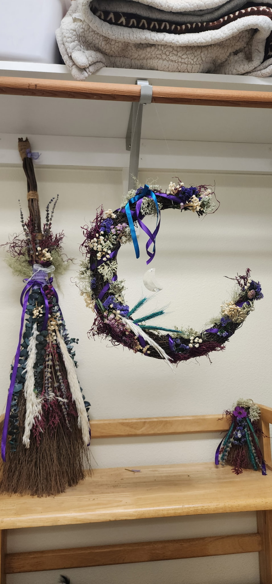 Moon wreath and besoms hanging in the studio